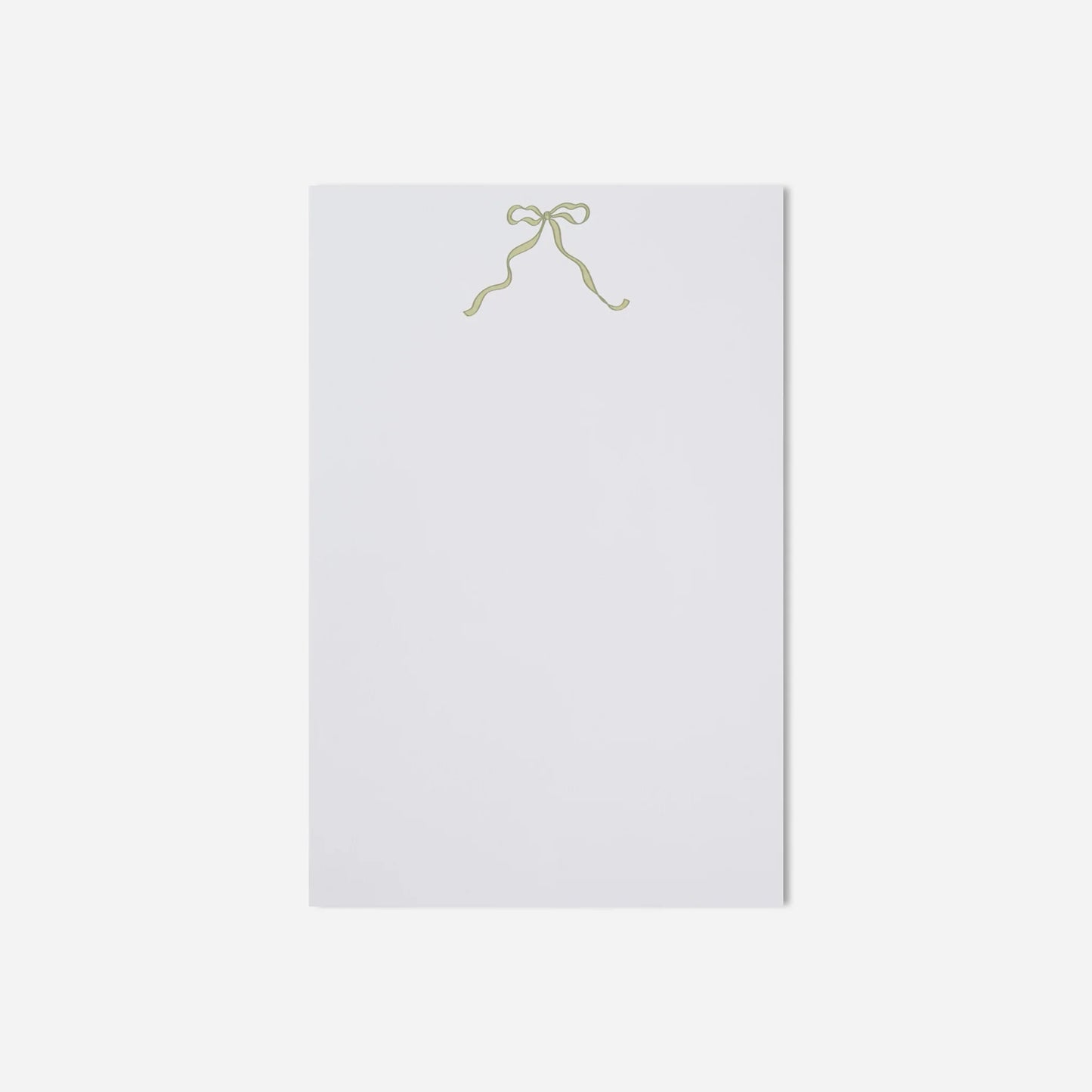White sheet of paper with a gold bow on a white background