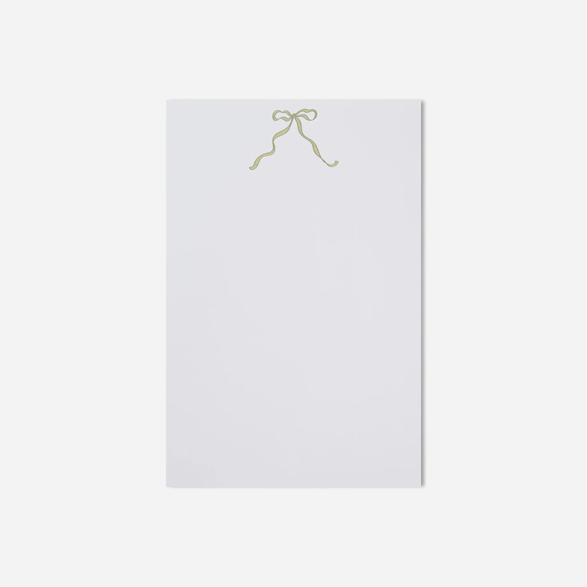 White sheet of paper with a gold bow on a white background