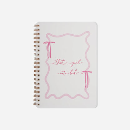 Notebook with pink design and text on a white background