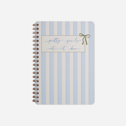 Notebook with blue and white striped cover and 'pretty girls note it down' text on a white background