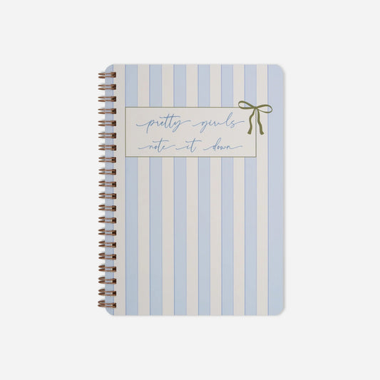 Notebook with blue and white striped cover and decorative text on a white background
