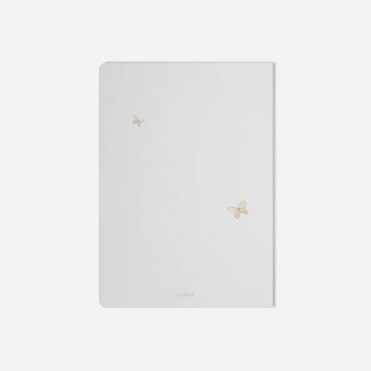 White notebook with floral designs on a light gray background