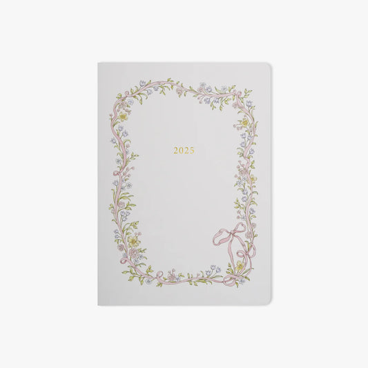 White planner with floral design and '2025' text on a white background