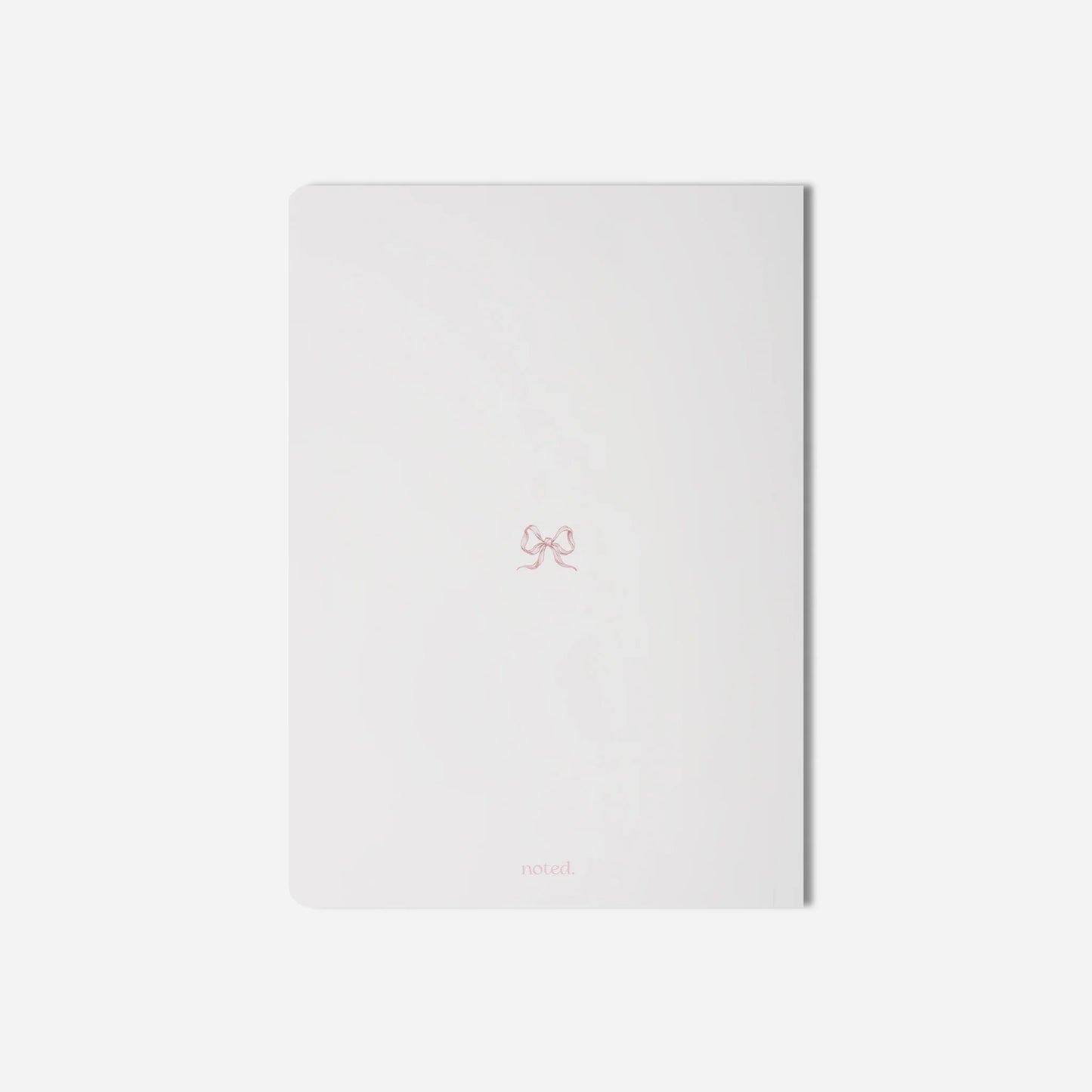 White notebook with a small logo on a light gray background