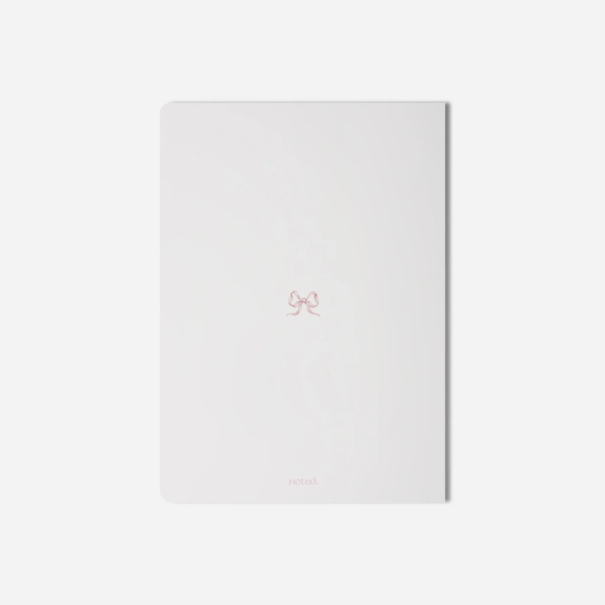 White notebook with a small logo on a light gray background