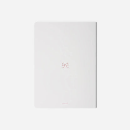 White notebook with a small logo on a light gray background
