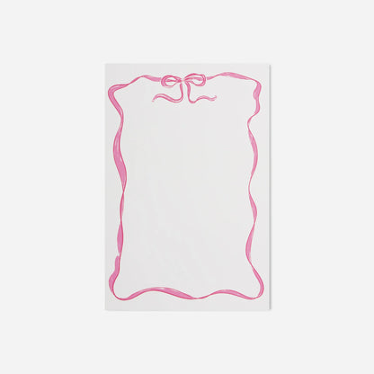 White notepad with pink decorative border on a white background