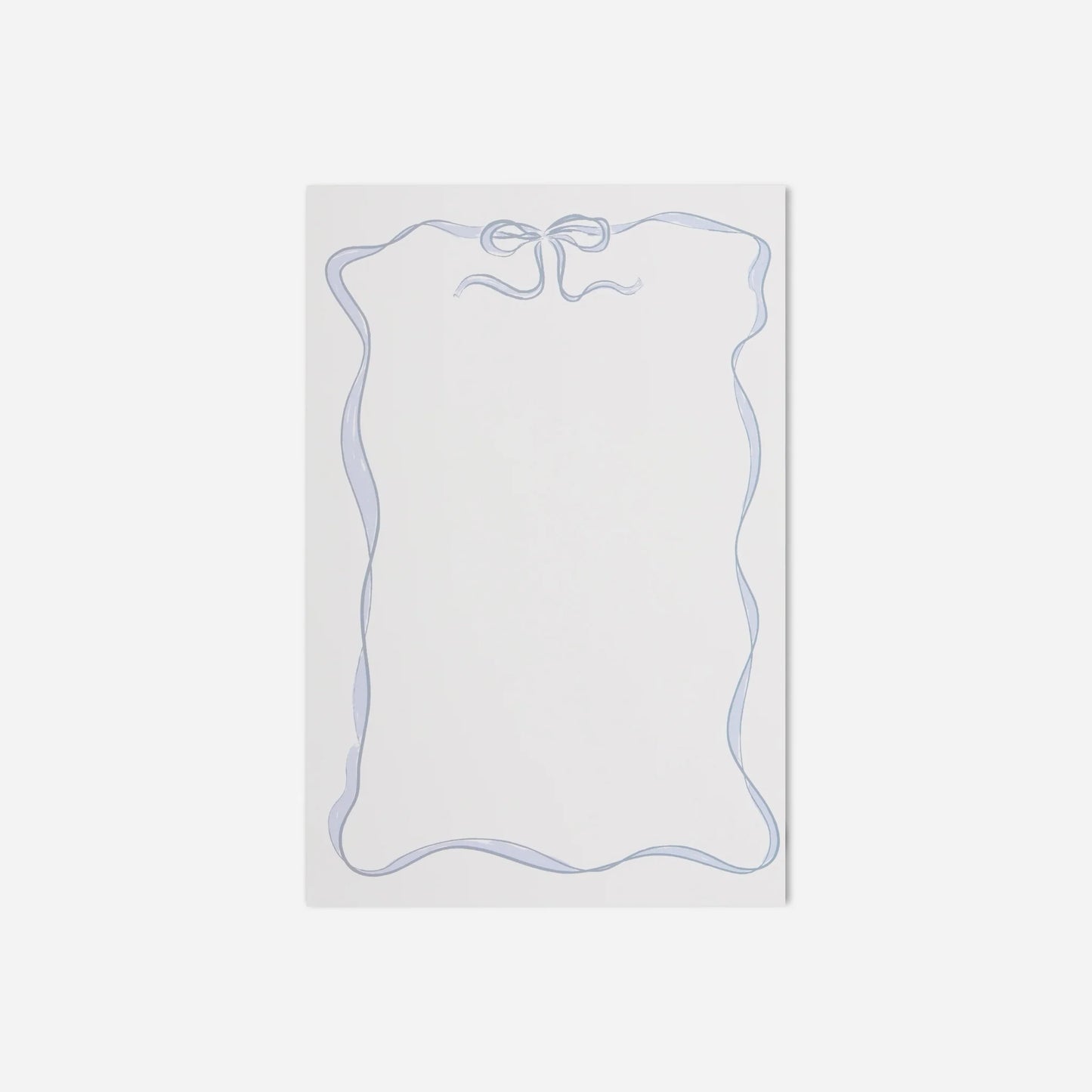 White notepad with blue border on a light gray background