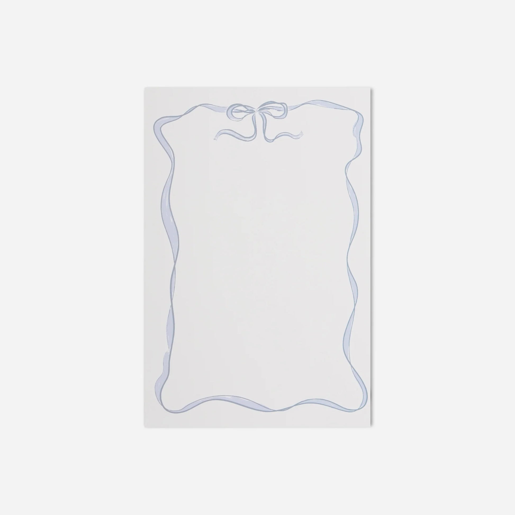 White notepad with blue border on a light gray background