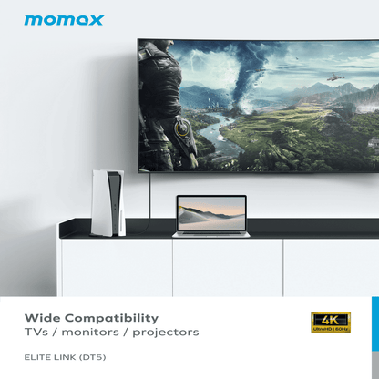 TV setup with laptop and speakers on a white wall, featuring Momax brand.