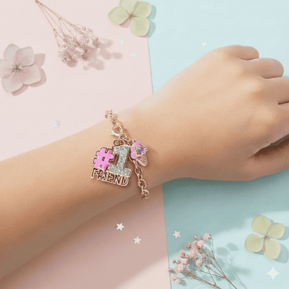 Bracelet with '#1 Friend' charm on a child's wrist against a soft, pastel background.