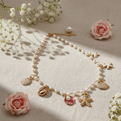 Necklace with shell and butterfly charms on a beige fabric background with flowers.