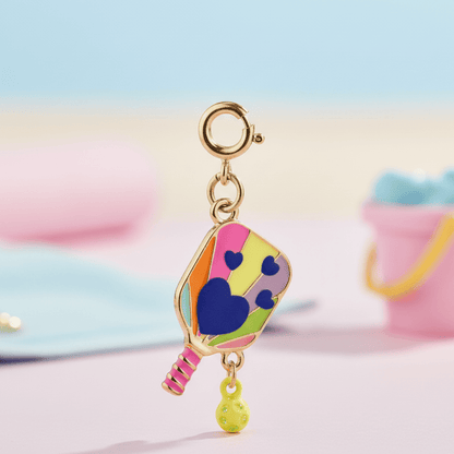 Colorful charm resembling a tennis racket with a heart design on a pastel background