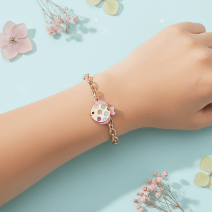 Child's wrist wearing a colorful bracelet with a blue background and flowers