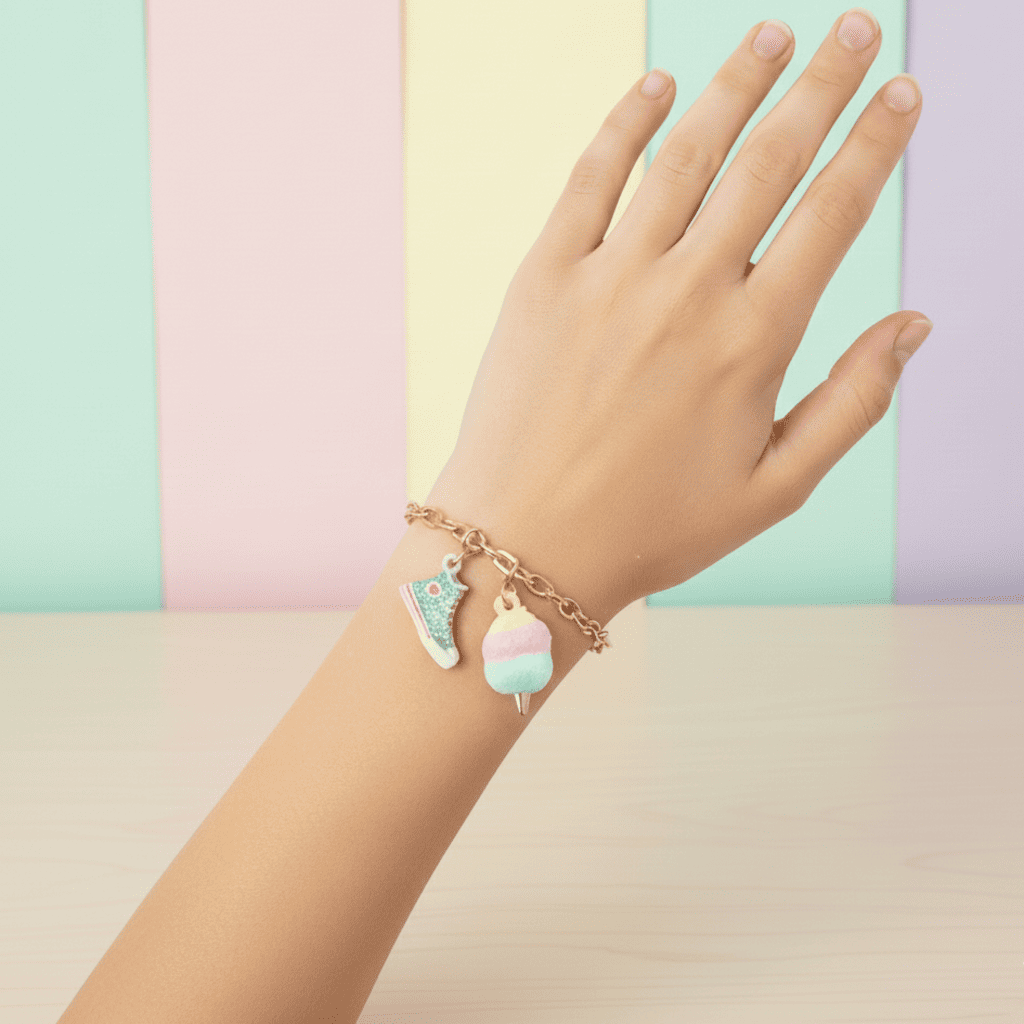 Hand wearing a bracelet with colorful charms against a pastel background