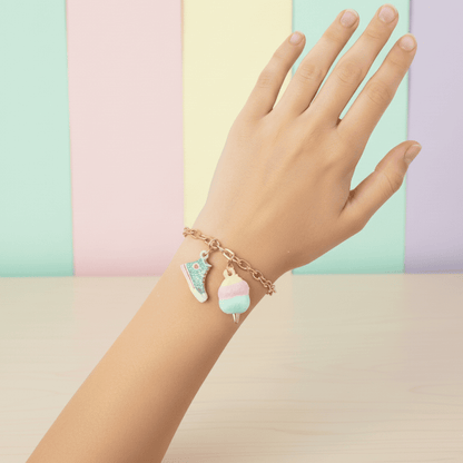 Hand wearing a bracelet with colorful charms against a pastel background
