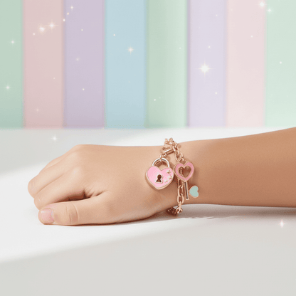 Hand wearing a bracelet with heart and lock charms against a pastel striped background
