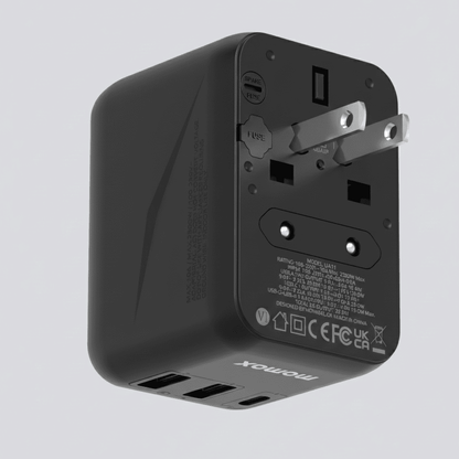 Black travel adapter with multiple ports on a light gray background