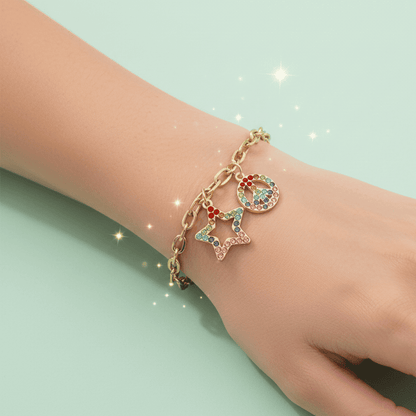 Gold bracelet with colorful charms on a light green background