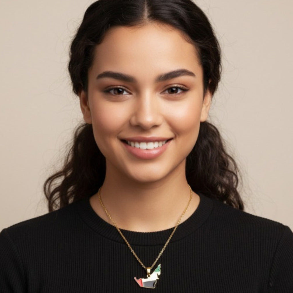 Woman wearing a black sweater and a necklace with a pendant against a beige background