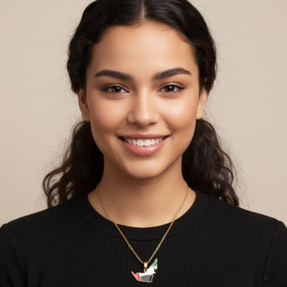 Woman wearing a black sweater and a necklace with a pendant against a beige background