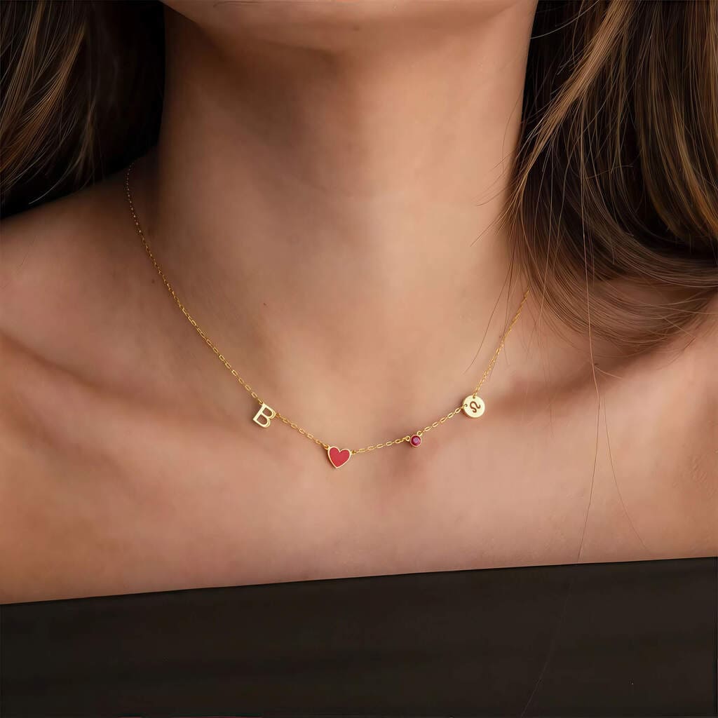 Gold necklace with letter 'B' and heart pendant on a person's neck