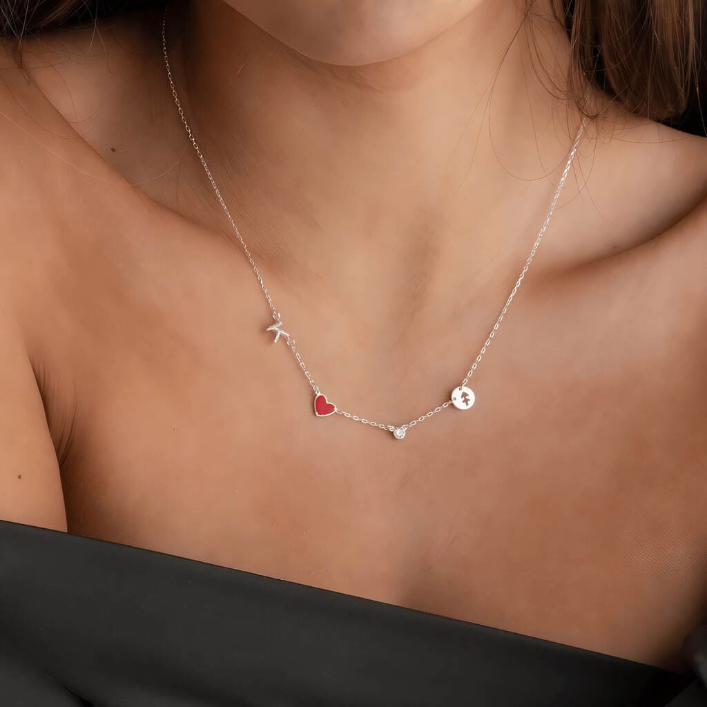 Necklace with heart and star pendants on a person's neck against a neutral background