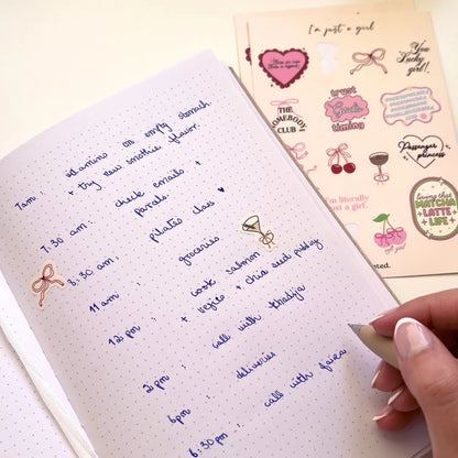 Handwritten notes on a notebook with decorative stickers