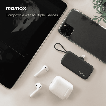 momax portable charger with phone, tablet, and AirPods on a light surface