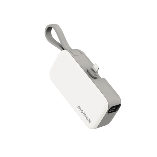 White power bank with gray strap on a green background
