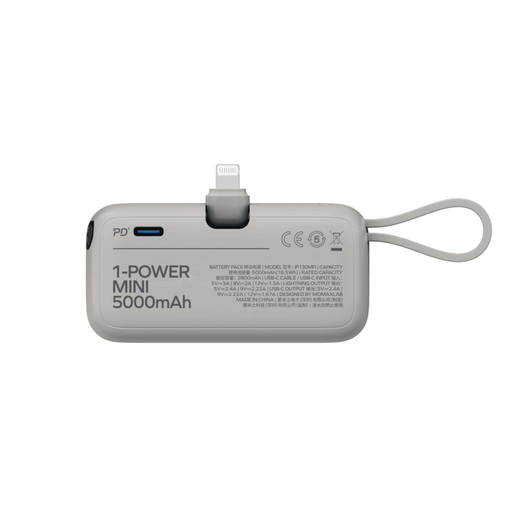 Gray power bank with USB-C and Lightning connectors on a green background