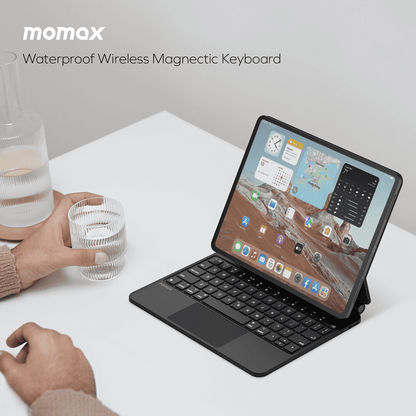 Tablet with a wireless magnetic keyboard on a white surface, featuring the Momax brand.
