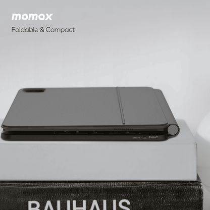 Momax foldable and compact product on a light gray background