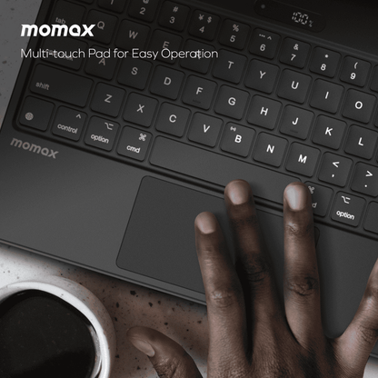 Momax multi-touch pad with keyboard and hand interacting on a dark background