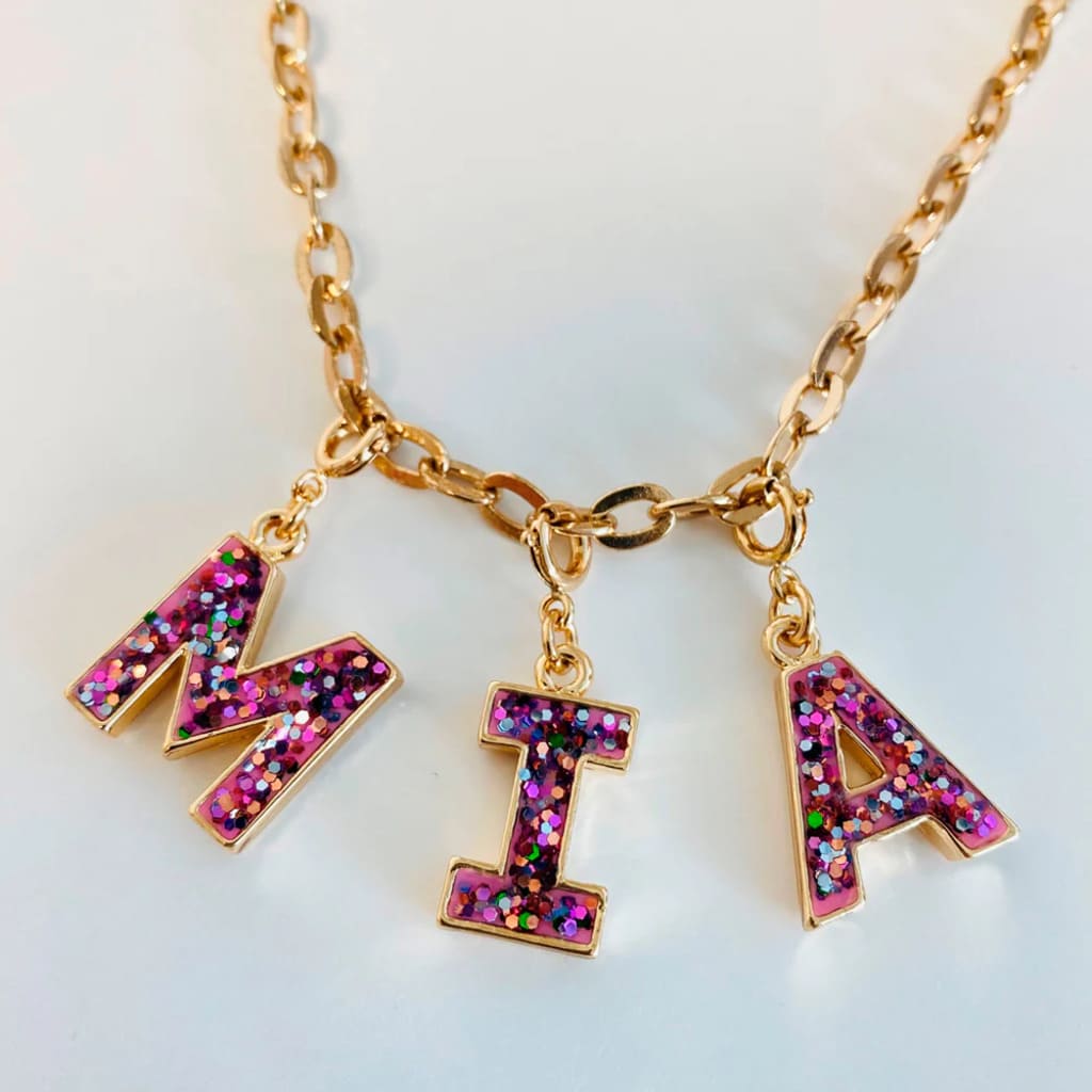 Necklace with colorful letter charms on a light background