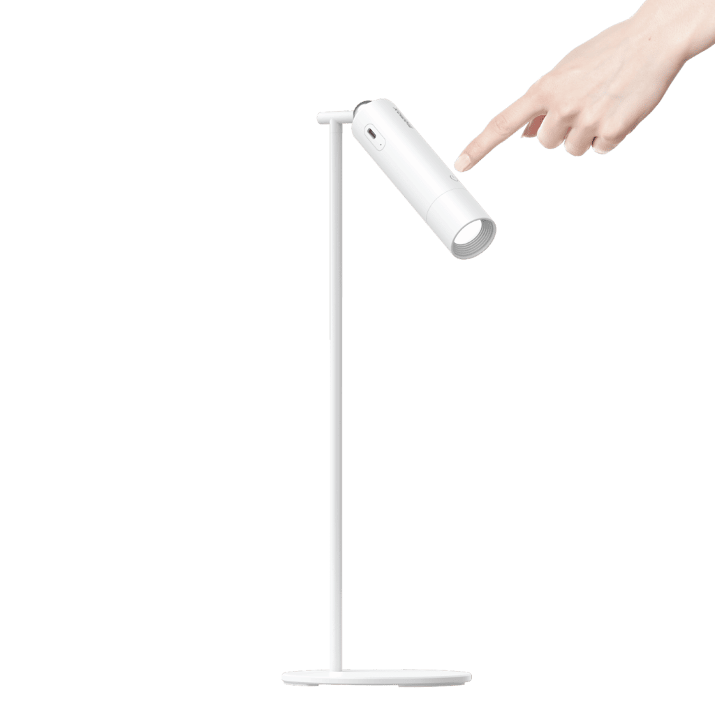 White LED desk lamp with a hand pointing at it on a green background
