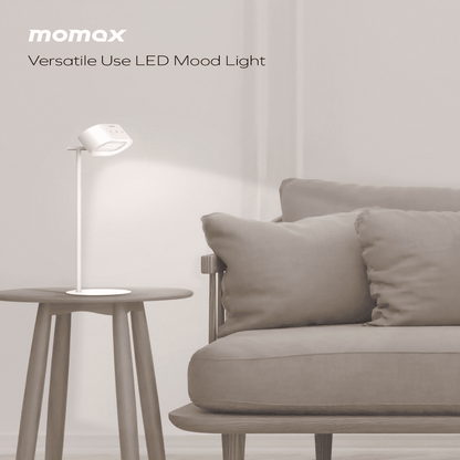 Momax LED mood light on a side table next to a sofa in a minimalistic room.
