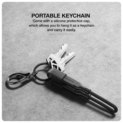 Portable keychain with silicone protective cap on a gray background