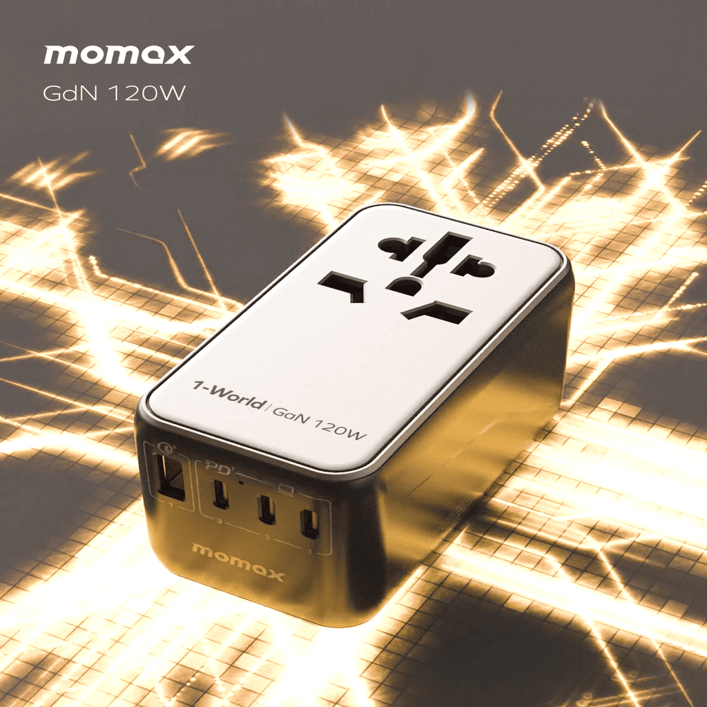 Momax GdN 120W power adapter on a textured surface with warm lighting