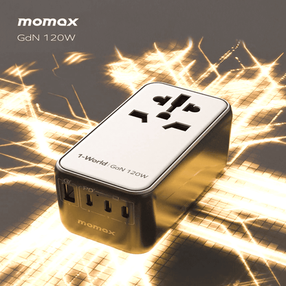 Momax GdN 120W power adapter on a textured surface with warm lighting