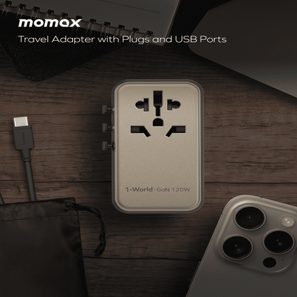Momax travel adapter with plugs and USB ports on a wooden surface with a phone and cable.