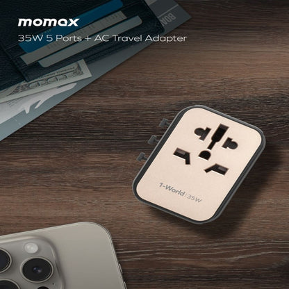 Momax 35W 5 Ports + AC Travel Adapter on a wooden surface with an iPhone and money.