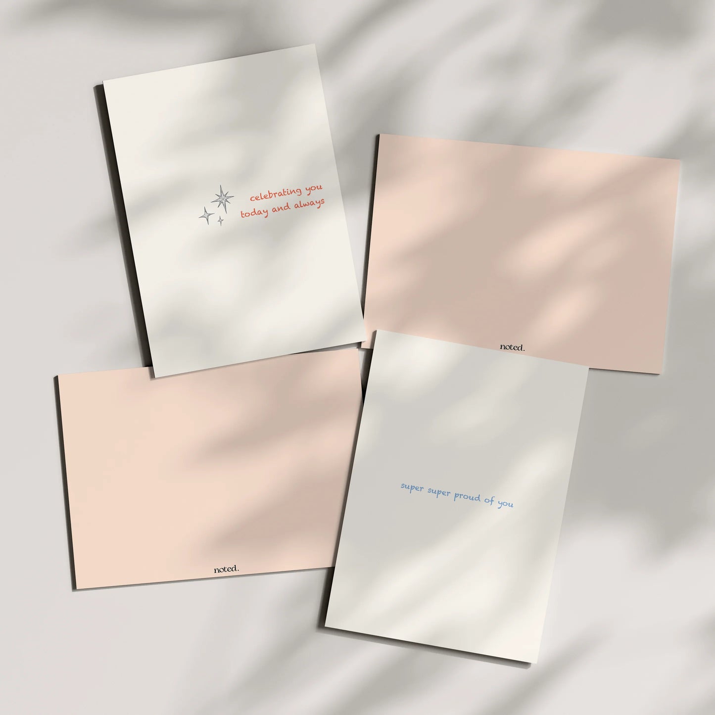 Four greeting cards with text on a light background