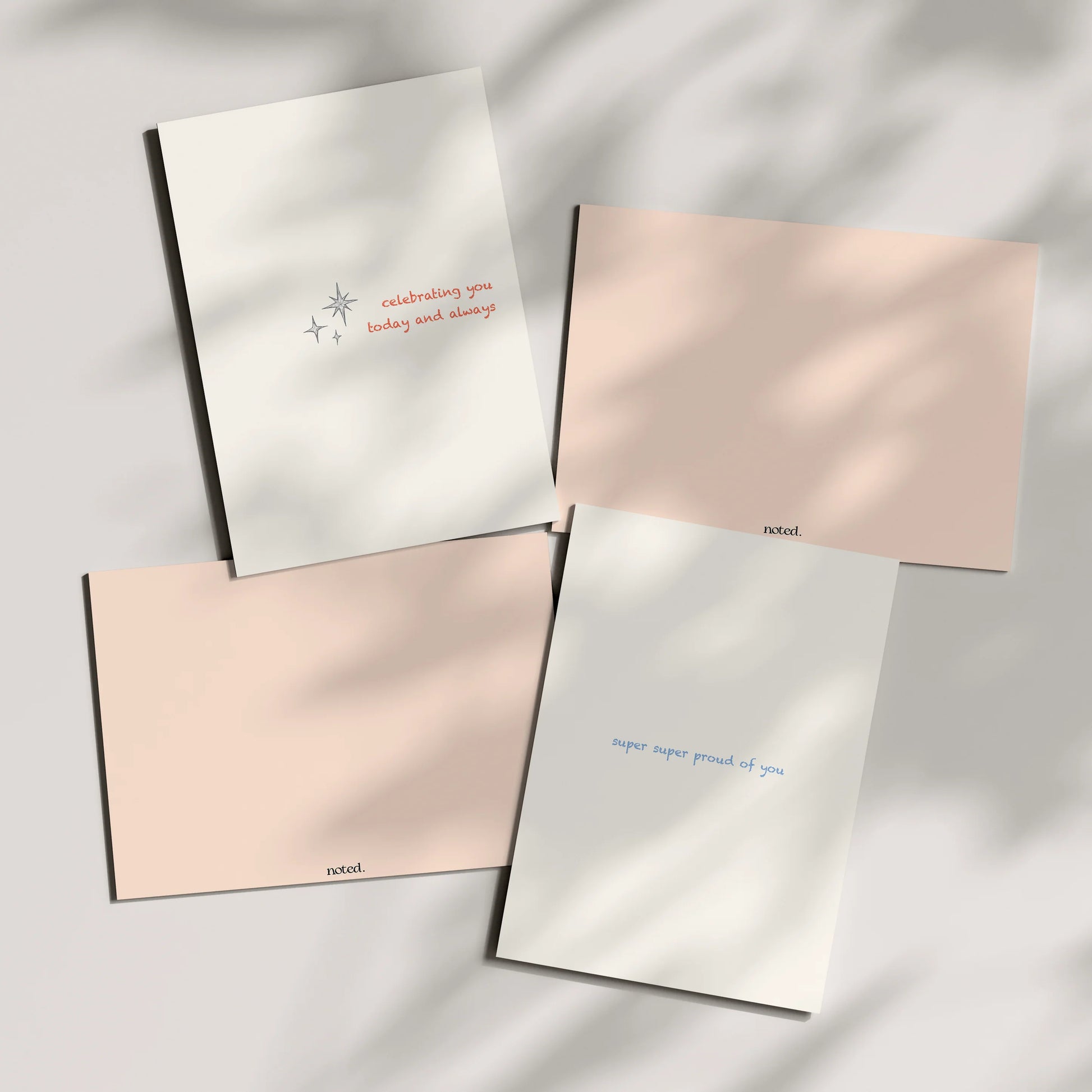 Four greeting cards with text on a light background