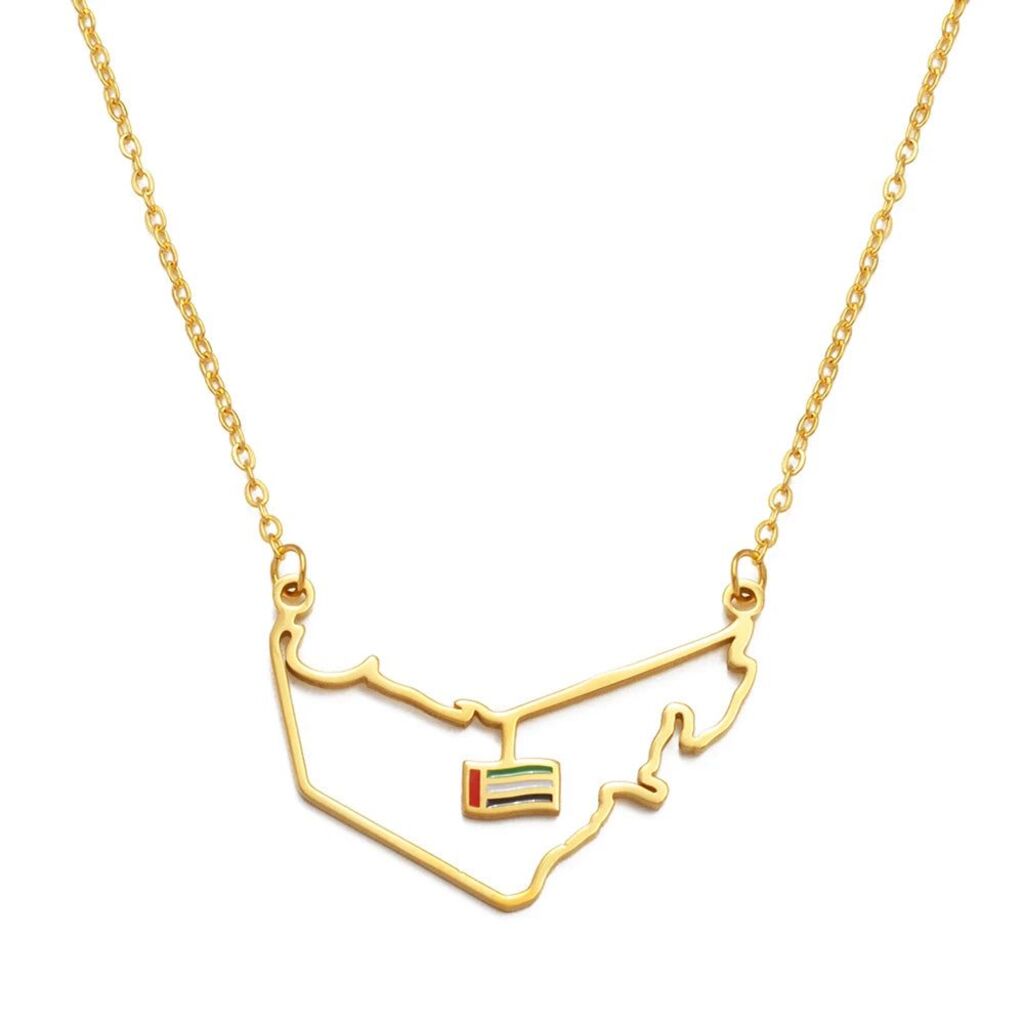 Gold necklace with a map-shaped pendant on a white background