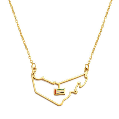 Gold necklace with a map-shaped pendant on a white background