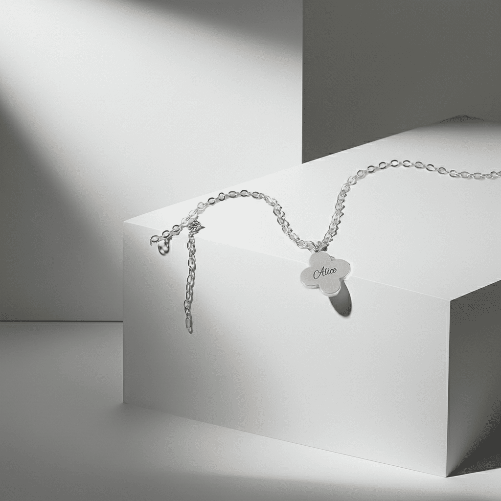Silver bracelet with a heart-shaped tag on a white and gray geometric background