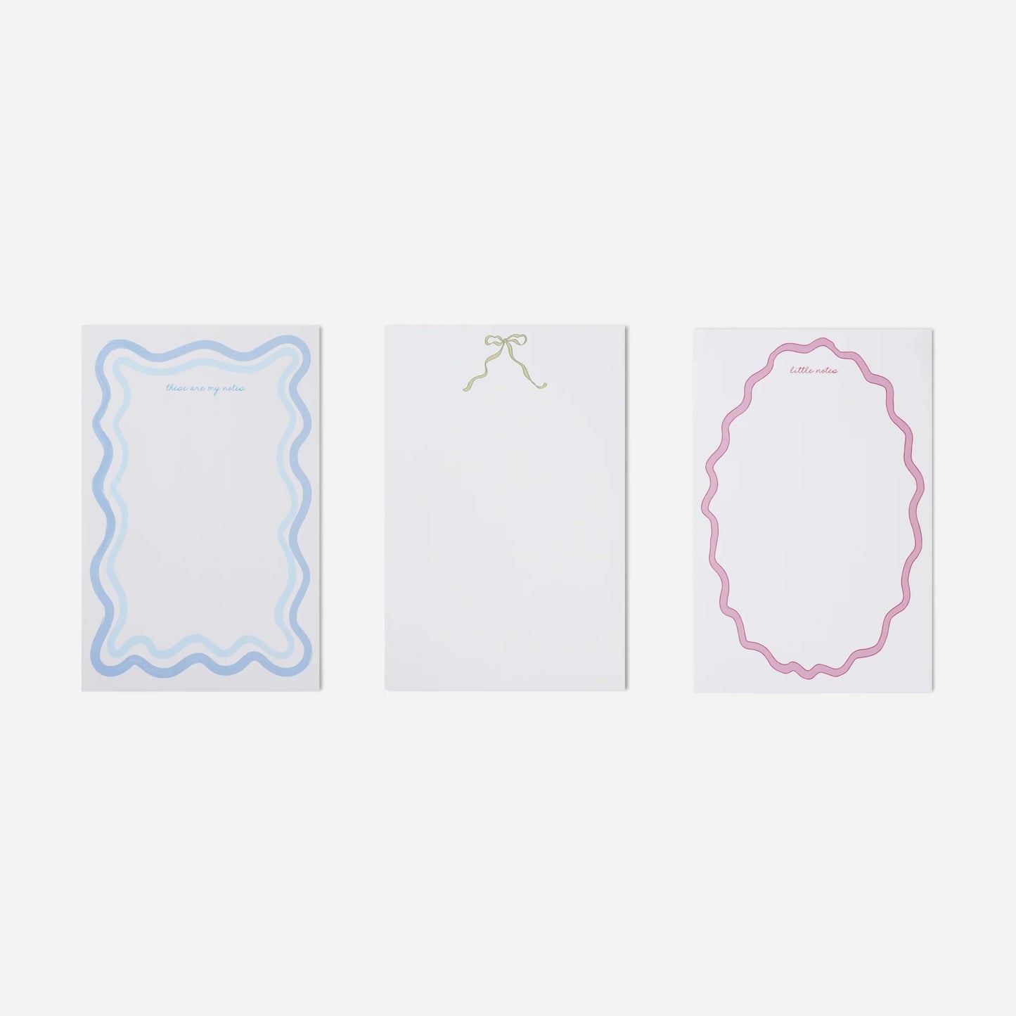 Three white cards with decorative borders on a light gray background