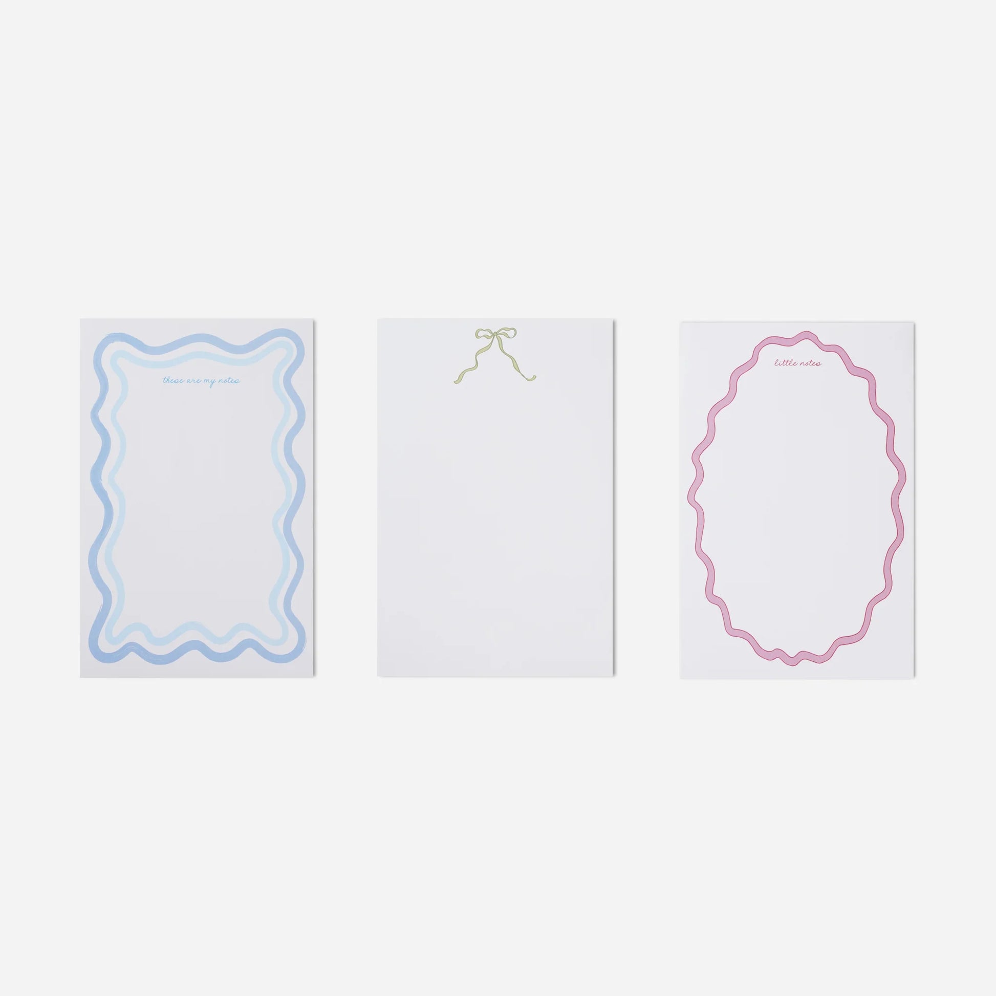 Three white cards with decorative borders on a light gray background